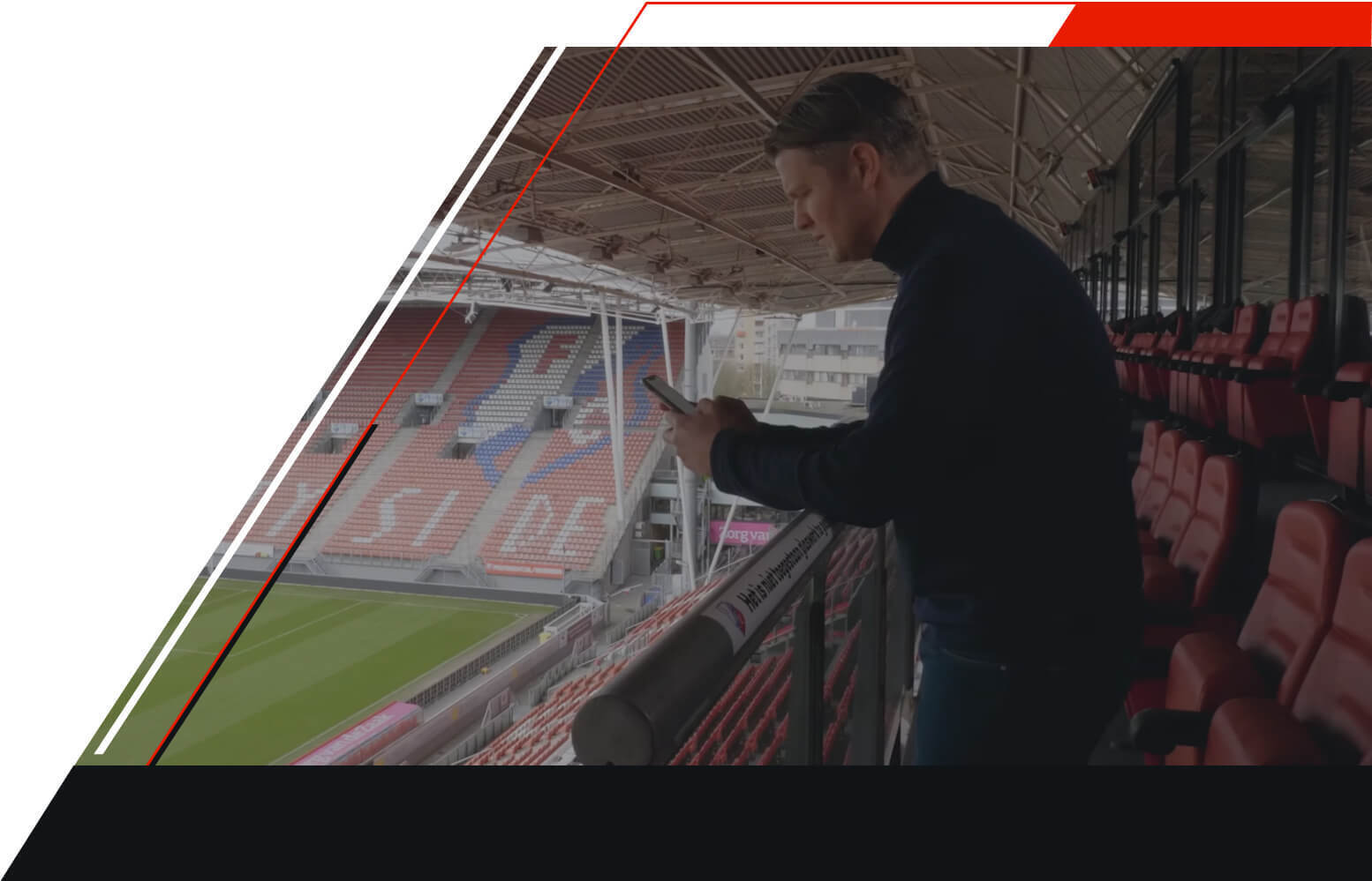 Man scouting with phone inside FC Utrecht stadium